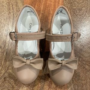 Capezio tan tap shoes with removable bow.
